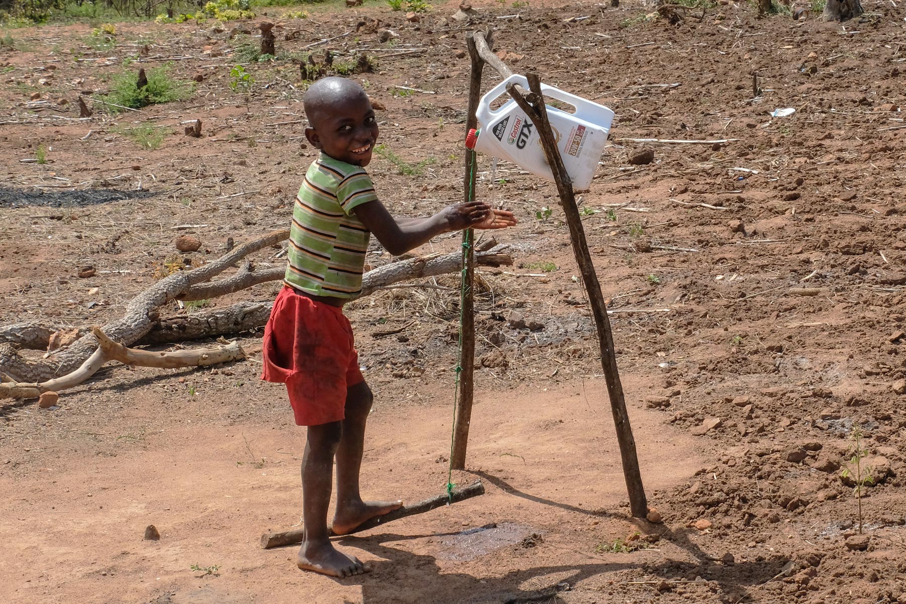 a child using a tippy tap